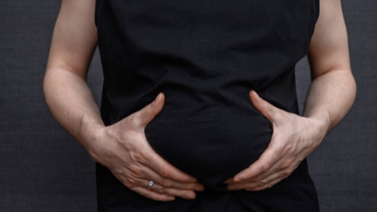 Person showing excess abdominal body fat